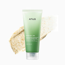 Green tube of anua facial cleanser with a beige scrub on a white background