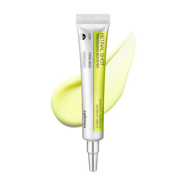 Skincare serum tube with a yellow smear on a white background