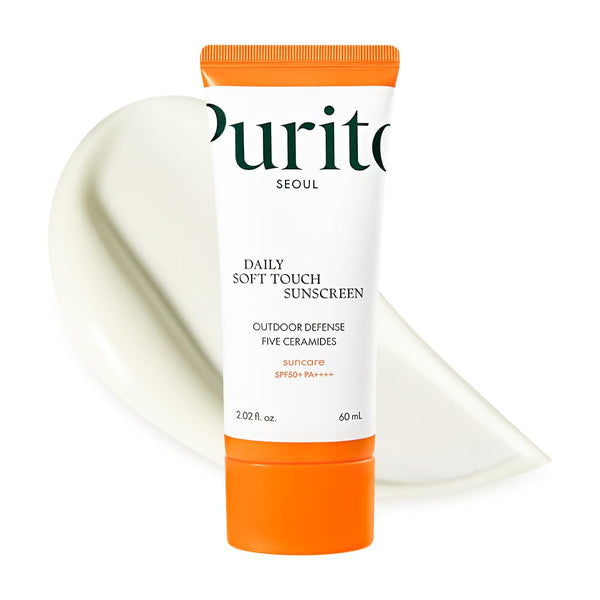 Purito Daily Soft Touch Sunscreen with orange and white packaging on a white background
