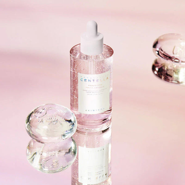 Skincare serum bottle with dropper on a pink background