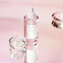 Skincare serum bottle with dropper on a pink background