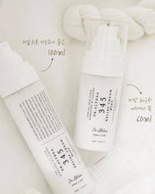 Two skincare products with labels on a light background